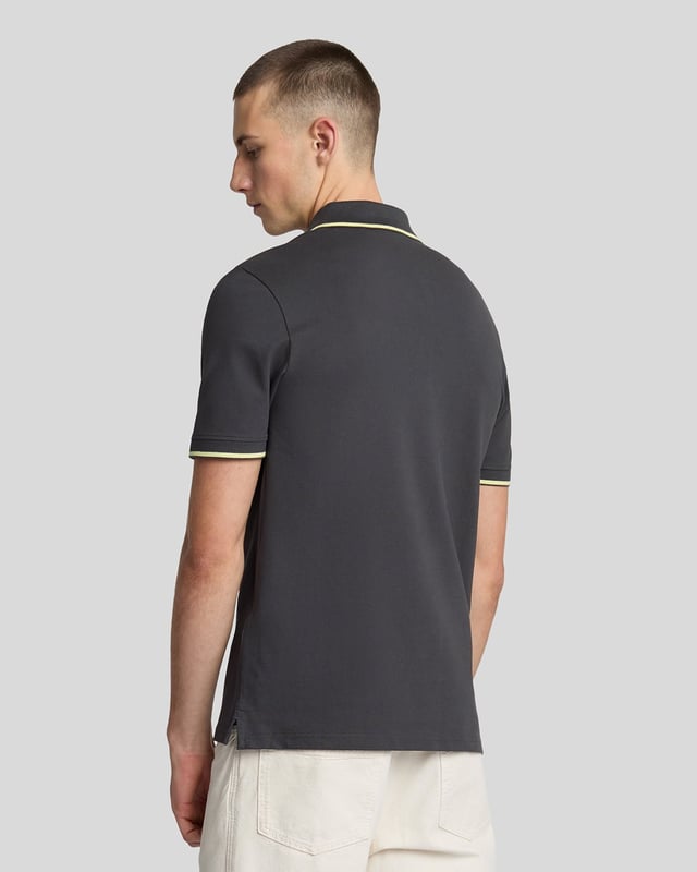 When people think of Lyle & Scott, they often think of polo shirts, so it stands to reason that we create the best polo shirts season after season. This one is cut for a classic fit in cotton jersey with a bit of added stretch and is finished with contrast tipping at the collar and cuffs for a slightly preppy look. - Classic collar 
- Front button fastening 
- Short sleeves 
- Tipped collar and cuffs
- Composition: 97% cotton, 3% elastane