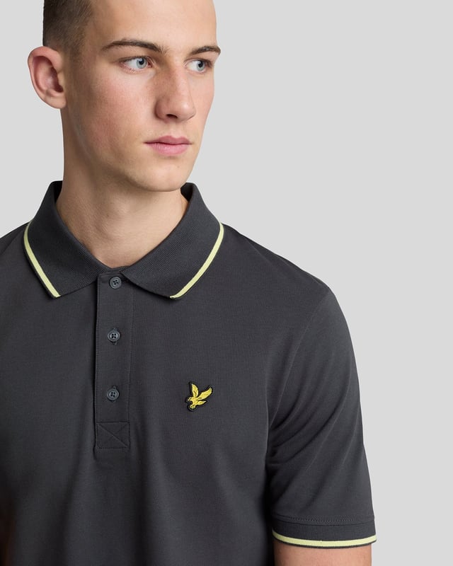 When people think of Lyle & Scott, they often think of polo shirts, so it stands to reason that we create the best polo shirts season after season. This one is cut for a classic fit in cotton jersey with a bit of added stretch and is finished with contrast tipping at the collar and cuffs for a slightly preppy look. - Classic collar 
- Front button fastening 
- Short sleeves 
- Tipped collar and cuffs
- Composition: 97% cotton, 3% elastane