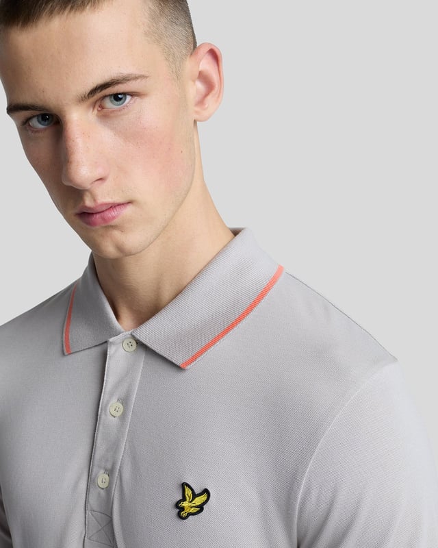 When people think of Lyle & Scott, they often think of polo shirts, so it stands to reason that we create the best polo shirts season after season. This one is cut for a classic fit in cotton jersey with a bit of added stretch and is finished with contrast tipping at the collar and cuffs for a slightly preppy look. - Classic collar 
- Front button fastening 
- Short sleeves 
- Tipped collar and cuffs
- Composition: 97% cotton, 3% elastane