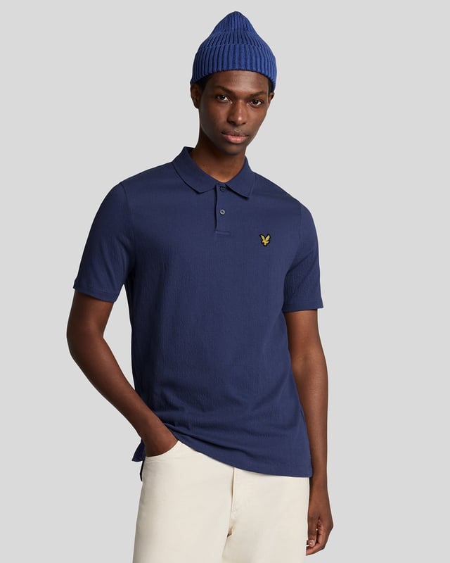 Introducing the Crepe Polo Shirt, a pinnacle of sophistication in our Spring menswear collection. This elegant piece features a refined relaxed fit and is crafted from a luxurious blend of 98% cotton and 2% elastane, ensuring ultimate comfort and mobility. Thoughtfully designed with a two-button placket and adorned with the distinctive Golden Eagle tab on the left chest, this polo exemplifies timeless style and versatility.

- Composition: 98% Cotton, 2% Elastane
- Fit: Relaxed
- Logo Branding: Golden Eagle tab
- Logo Placement: Left chest
- Versatile styling for casual and semi-formal occasions

Elevate your wardrobe with this sophisticated polo, perfect for the discerning gentleman this spring.
