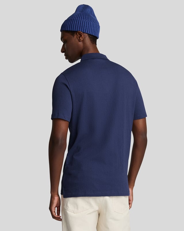 Introducing the Crepe Polo Shirt, a pinnacle of sophistication in our Spring menswear collection. This elegant piece features a refined relaxed fit and is crafted from a luxurious blend of 98% cotton and 2% elastane, ensuring ultimate comfort and mobility. Thoughtfully designed with a two-button placket and adorned with the distinctive Golden Eagle tab on the left chest, this polo exemplifies timeless style and versatility.

- Composition: 98% Cotton, 2% Elastane
- Fit: Relaxed
- Logo Branding: Golden Eagle tab
- Logo Placement: Left chest
- Versatile styling for casual and semi-formal occasions

Elevate your wardrobe with this sophisticated polo, perfect for the discerning gentleman this spring.