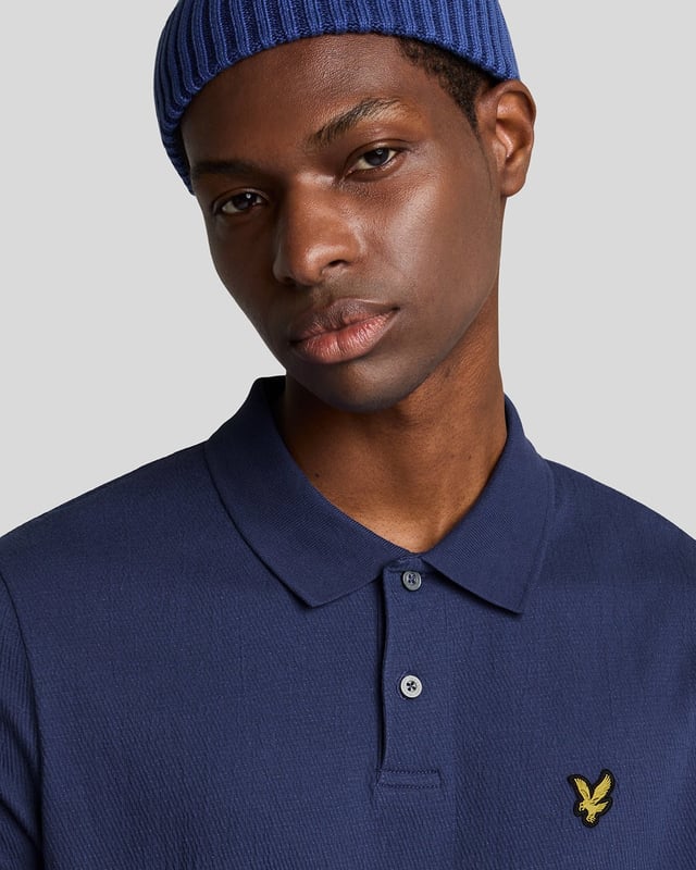 Introducing the Crepe Polo Shirt, a pinnacle of sophistication in our Spring menswear collection. This elegant piece features a refined relaxed fit and is crafted from a luxurious blend of 98% cotton and 2% elastane, ensuring ultimate comfort and mobility. Thoughtfully designed with a two-button placket and adorned with the distinctive Golden Eagle tab on the left chest, this polo exemplifies timeless style and versatility.

- Composition: 98% Cotton, 2% Elastane
- Fit: Relaxed
- Logo Branding: Golden Eagle tab
- Logo Placement: Left chest
- Versatile styling for casual and semi-formal occasions

Elevate your wardrobe with this sophisticated polo, perfect for the discerning gentleman this spring.
