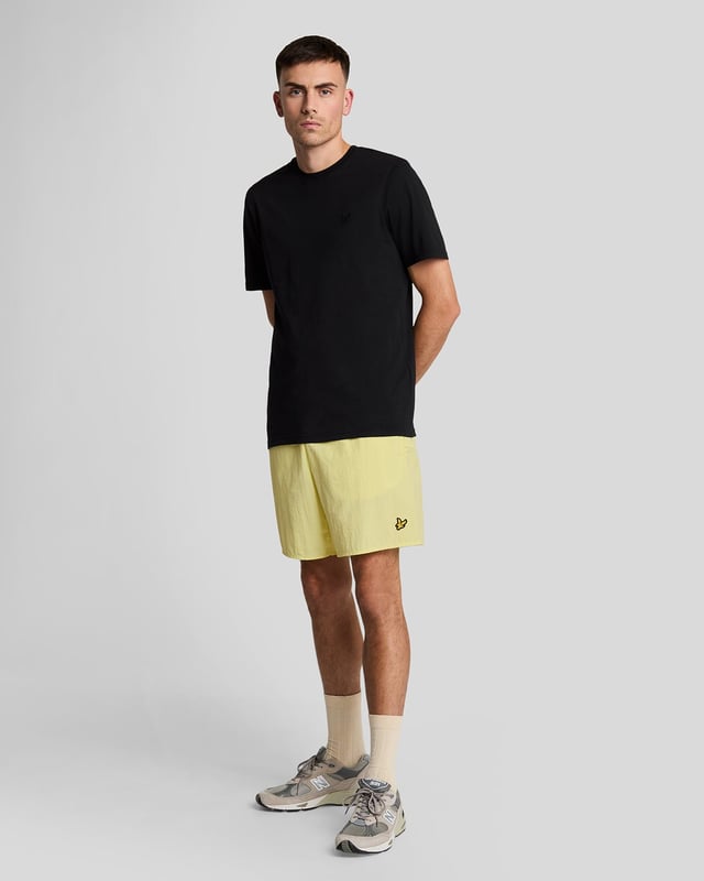 Finished with our signature Golden Eagle, these mesh-lined plain swim shorts, with fast-drying fabric, deliver the iconic Lyle & Scott style both in and out of the pool.