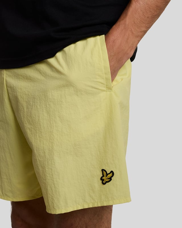Finished with our signature Golden Eagle, these mesh-lined plain swim shorts, with fast-drying fabric, deliver the iconic Lyle & Scott style both in and out of the pool.