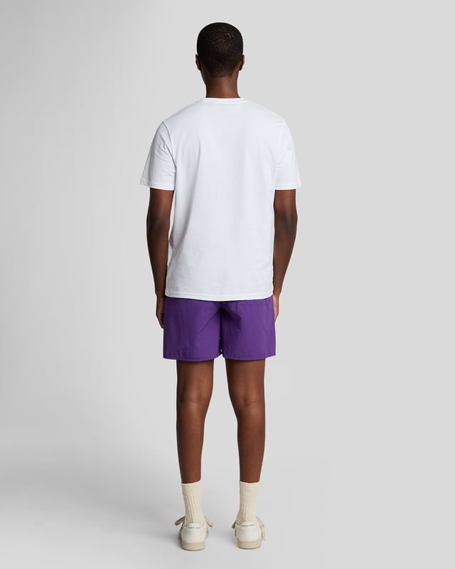 Finished with our signature Golden Eagle, these mesh-lined plain swim shorts, with fast-drying fabric, deliver the iconic Lyle & Scott style both in and out of the pool.