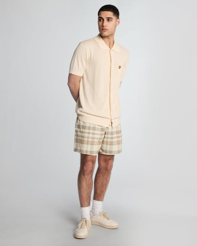 Introducing the Tartan Resort Swim Shorts, an exquisite addition to our spring menswear collection. Meticulously crafted from 100% premium polyester, these shorts embody sophistication and comfort, featuring a ribbed waistband with a drawcord for a personalized fit and inset side pockets for practicality. Completed with a distinguished golden embroidered eagle logo on the bottom leg, these swim shorts effortlessly blend style with functionality for the discerning gentleman.

- Material: 100% Polyester
- Fit: Regular
- Features: Ribbed waist band, drawcord, inset side pockets
- Logo: Golden embroidered eagle
- Versatile styling for resort transitions

Elevate your swimwear repertoire with the Tartan Resort Swim Shorts, a refined choice for the discerning gentleman this spring.
