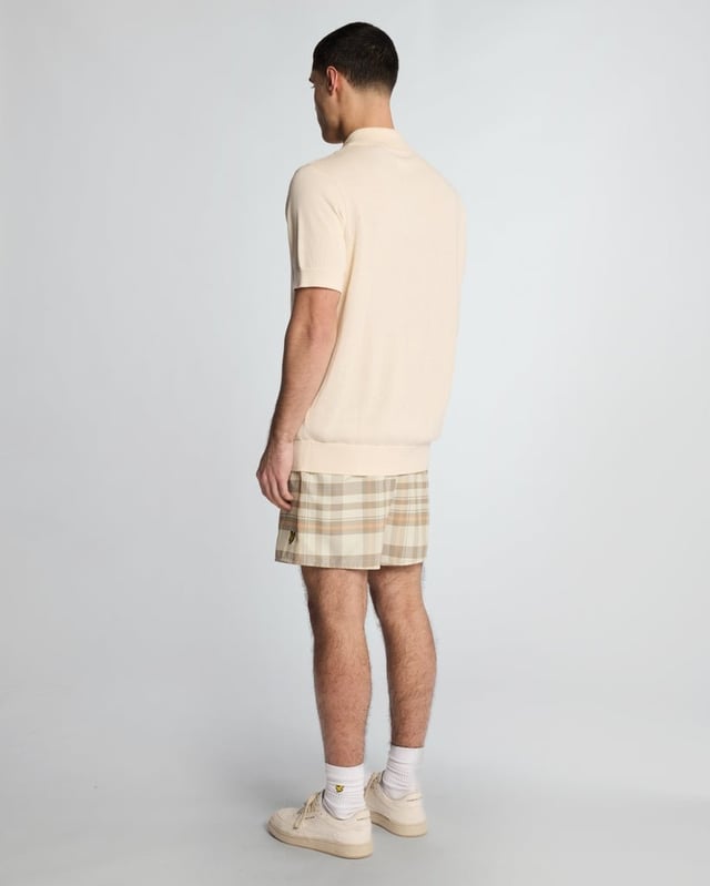 Introducing the Tartan Resort Swim Shorts, an exquisite addition to our spring menswear collection. Meticulously crafted from 100% premium polyester, these shorts embody sophistication and comfort, featuring a ribbed waistband with a drawcord for a personalized fit and inset side pockets for practicality. Completed with a distinguished golden embroidered eagle logo on the bottom leg, these swim shorts effortlessly blend style with functionality for the discerning gentleman.

- Material: 100% Polyester
- Fit: Regular
- Features: Ribbed waist band, drawcord, inset side pockets
- Logo: Golden embroidered eagle
- Versatile styling for resort transitions

Elevate your swimwear repertoire with the Tartan Resort Swim Shorts, a refined choice for the discerning gentleman this spring.