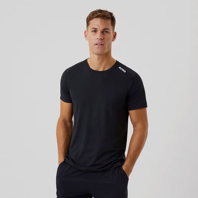 Borg Athletic T-shirt - High-Performance Activewear: Train in ultimate comfort with the Björn Borg Borg Athletic T-shirt, designed for peak performance. Made from lightweight, recycled polyester stretch, this T-shirt offers high moisture-wicking functionality and breathability, ensuring you stay dry and cool during intense workouts. It features a regular fit with strategically placed cutlines to minimize pressure on the shoulders and sides, making it ideal for all types of physical activity. Extra Product Details:. 93% Recycled Polyester, 7% Elastane Moisture-Wicking Fabric High Breathability Strategic Cutlines for Comfort Machine Washable. This T-shirt combines sustainability with top-notch performance, making it a must-have for any fitness enthusiast.