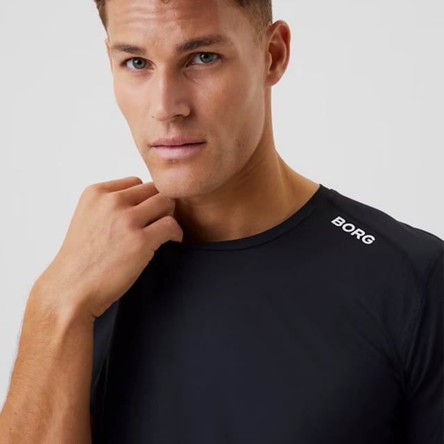 Borg Athletic T-shirt - High-Performance Activewear: Train in ultimate comfort with the Björn Borg Borg Athletic T-shirt, designed for peak performance. Made from lightweight, recycled polyester stretch, this T-shirt offers high moisture-wicking functionality and breathability, ensuring you stay dry and cool during intense workouts. It features a regular fit with strategically placed cutlines to minimize pressure on the shoulders and sides, making it ideal for all types of physical activity. Extra Product Details:. 93% Recycled Polyester, 7% Elastane Moisture-Wicking Fabric High Breathability Strategic Cutlines for Comfort Machine Washable. This T-shirt combines sustainability with top-notch performance, making it a must-have for any fitness enthusiast.