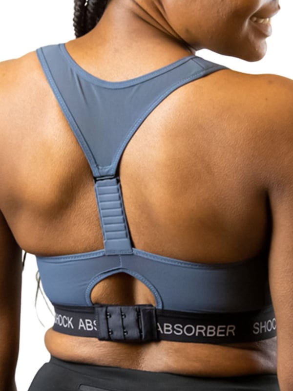 Shock Absorber InfinitY Power Sports Bra. Non-wired sports bra with moisture-wicking material, breathable padded cups, a zip front closure, racerback adjustable straps and a flattering moulded shape. Product is recommended hand-wash only.