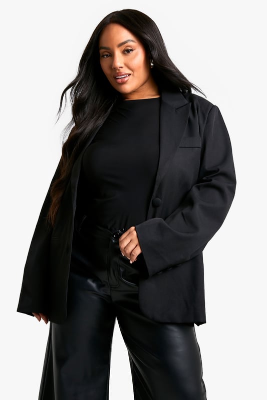 Oversized fit for a relaxed and contemporary silhouette
        Single-breasted design with notched lapels
        Long sleeves with button cuffs for a polished finish
        Front button closure for easy wear
        Versatile plus-size option suitable for various occasions
    
    Make a bold statement with this oversized blazer, perfect for the fashion-forward woman who loves to stay on-trend. The relaxed fit offers comfort without compromising on style, making it an ideal choice for both casual outings and semi-formal events. Pair it with wide-leg trousers and a simple top for a chic office look, or throw it over a bodycon dress for a night out with the girls. The single-breasted design and notched lapels add a touch of classic tailoring to this contemporary piece. Whether you're heading to a family gathering or a casual lunch date, this blazer will effortlessly elevate your ensemble. Its versatility allows for endless styling options - belt it for a more defined silhouette or leave it open for a laid-back vibe. This Boohoo blazer is your go-to piece for creating looks that radiate confidence and style.