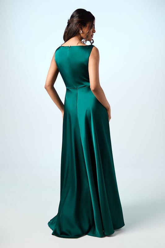Elegant sleeveless maxi dress with a graceful cowl neckline that drapes beautifully
        Luxurious satin fabric that catches the light with subtle sheen
        Petite-friendly design with proportions tailored for shorter frames
        Flattering pleated detail that creates a flowing silhouette
        Floor-length design with a clean, sophisticated line perfect for formal occasions
    
    The Honoured Petite Bridesmaid Dress from Coast embodies timeless elegance with its fluid satin construction and graceful cowl neckline. Designed specifically for petite frames, this maxi dress offers both comfort and sophistication for your special role in the bridal party. The sleeveless cut allows for ease of movement throughout the celebration, while the pleated detailing creates a flattering shape that moves beautifully as you walk down the aisle. Complete your bridesmaid ensemble with delicate drop earrings and a simple bracelet as shown on our model, keeping accessories minimal to complement the dress's refined aesthetic. For a coordinated bridal party look, this style can be harmonised with other Coast bridesmaid dresses in matching tones, creating a cohesive and memorable wedding day aesthetic that will photograph beautifully alongside the bride.