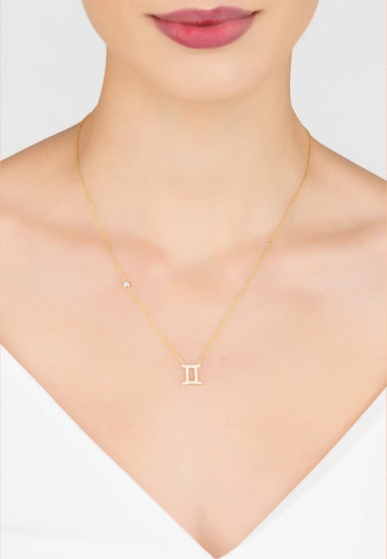 Made of 925 sterling silver, dipped in 22ct gold. This necklace is hand set with multifaceted white zircons.Geminis celebrate birthdays May 21 - June 20Finished with a lobster clasp, and size adjusterDimensions: Necklace can be worn 40cm chain length or 45cm chain length using adjuster. Motif 1.5cm x 1cmPackaging:This item is presented in a Latelita London signature packagingCare Instructions:To maintain your jewellery, wipe gently with a damp cloth that is soft and clean. Do not soak in water. Avoid contact with soaps, detergents, perfume or hair spray.