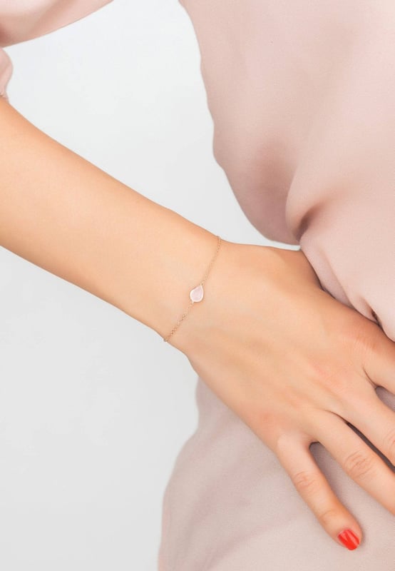 Introducing the Pisa Mini Teardrop Bracelet, a dainty and delicate accessory for those who like understated elegance. A tiny gemstone is set on a fine chain that has been handcrafted in 925 sterling silver and dipped in 22ct rosegold. This bracelet is available in a variety of sweets hues that will look great with all of your favourite clothing.This bracelet, which is inspired by the glitz and glamour of the Italian Riviera combined with the understated elegance of European design, is a thoughtful present for a birthday, loved one, or as a small favour for bridesmaids. Finishing details include a lobster clasp and size adjuster (15 to 17.5cm) making it easy to find the perfect fit. This bracelet is also lightweight (1.1g), making it comfortable to wear all day long.The rose quartz is the secondary and complimentary birthstone for January. It is a stone that symbolizes love, compassion, and healing. It is said to be helpful in attracting and maintaining relationships. It is also believed to promote self-love and self-esteem. Rose quartz is a popular choice for jewellery because of its beauty and meaning.Do you want to add a little colour to your wardrobe? Check out the full collection and discover the perfect piece for you or a loved one.