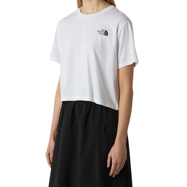 The North Face Women's Simple Dome Cropped Top T-Shirt is a casual, short-sleeved tee perfect for the spring and summer seasons. Made from comfortable cotton material, this pullover shirt features a crew neck and a cropped fit for a stylish look. With its regular fit and stretchy design, this tee from The North Face is easy to care for with machine washable instructions, making it a practical and fashionable choice for any woman's wardrobe.