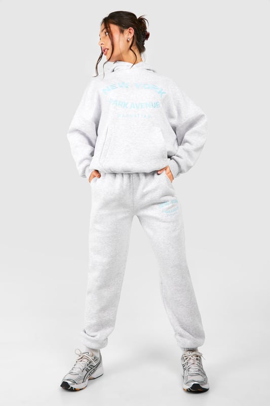Cosy tracksuit with New York embroidery
        Relaxed fit hoodie with ribbed cuffs and hem
        Matching joggers with tapered leg
        Soft cotton-feel fabric for ultimate comfort
        Versatile two-piece set for effortless styling
    
    Embrace laid-back chic with this petite tracksuit, perfect for those who want to make a statement whilst staying comfortable. The New York embroidery adds a touch of urban flair, making it ideal for city dwellers and travellers alike. Style this set with chunky trainers for a casual day out, or dress it up with statement jewellery and heeled boots for an evening with friends. The versatility of this tracksuit means it can take you from lounging at home to running errands in town with ease. For a sporty look, pair with a baseball cap and crossbody bag. This tracksuit is a must-have for your casual wardrobe, offering both style and comfort for various informal occasions.