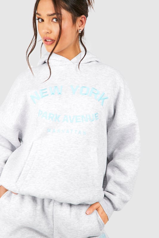 Cosy tracksuit with New York embroidery
        Relaxed fit hoodie with ribbed cuffs and hem
        Matching joggers with tapered leg
        Soft cotton-feel fabric for ultimate comfort
        Versatile two-piece set for effortless styling
    
    Embrace laid-back chic with this petite tracksuit, perfect for those who want to make a statement whilst staying comfortable. The New York embroidery adds a touch of urban flair, making it ideal for city dwellers and travellers alike. Style this set with chunky trainers for a casual day out, or dress it up with statement jewellery and heeled boots for an evening with friends. The versatility of this tracksuit means it can take you from lounging at home to running errands in town with ease. For a sporty look, pair with a baseball cap and crossbody bag. This tracksuit is a must-have for your casual wardrobe, offering both style and comfort for various informal occasions.