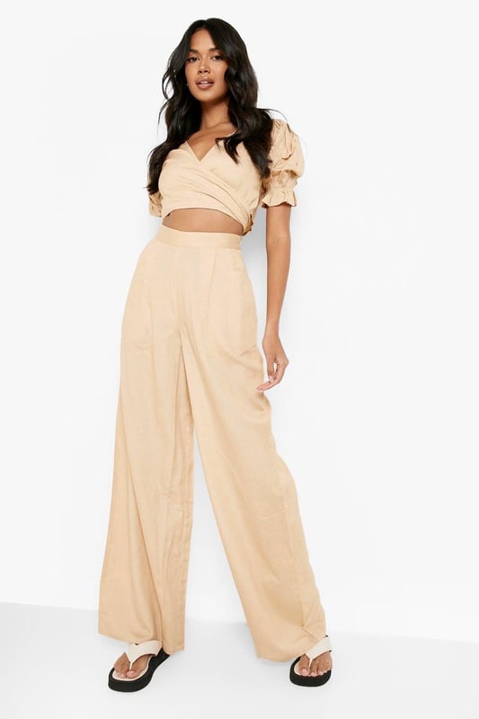 Wide leg design for a relaxed, breezy silhouette
        High-waisted fit accentuates the waistline
        Linen-look fabric offers a lightweight, breathable feel
        Side pockets add functionality to the stylish design
        Versatile trousers suitable for various casual occasions
    
    Embrace effortless chic with these wide leg relaxed fit trousers from Boohoo. The linen-look fabric lends a laid-back, summery vibe to your ensemble, perfect for those balmy days and casual outings. Style these trousers with a cropped wrap top for a coordinated look that's both trendy and comfortable. The high-waisted design flatters your figure, while the relaxed fit through the legs ensures unrestricted movement. Pair with flat sandals for a day of shopping or dress up with wedges for a casual dinner date. These trousers are a versatile addition to your wardrobe, easily transitioning from beachside strolls to family gatherings. The side pockets offer practicality without compromising on style. For a complete look, accessorise with oversized sunglasses and a woven tote bag, channelling that effortless British summer style.