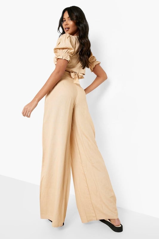 Wide leg design for a relaxed, breezy silhouette
        High-waisted fit accentuates the waistline
        Linen-look fabric offers a lightweight, breathable feel
        Side pockets add functionality to the stylish design
        Versatile trousers suitable for various casual occasions
    
    Embrace effortless chic with these wide leg relaxed fit trousers from Boohoo. The linen-look fabric lends a laid-back, summery vibe to your ensemble, perfect for those balmy days and casual outings. Style these trousers with a cropped wrap top for a coordinated look that's both trendy and comfortable. The high-waisted design flatters your figure, while the relaxed fit through the legs ensures unrestricted movement. Pair with flat sandals for a day of shopping or dress up with wedges for a casual dinner date. These trousers are a versatile addition to your wardrobe, easily transitioning from beachside strolls to family gatherings. The side pockets offer practicality without compromising on style. For a complete look, accessorise with oversized sunglasses and a woven tote bag, channelling that effortless British summer style.