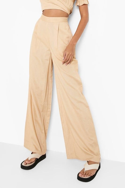 Wide leg design for a relaxed, breezy silhouette
        High-waisted fit accentuates the waistline
        Linen-look fabric offers a lightweight, breathable feel
        Side pockets add functionality to the stylish design
        Versatile trousers suitable for various casual occasions
    
    Embrace effortless chic with these wide leg relaxed fit trousers from Boohoo. The linen-look fabric lends a laid-back, summery vibe to your ensemble, perfect for those balmy days and casual outings. Style these trousers with a cropped wrap top for a coordinated look that's both trendy and comfortable. The high-waisted design flatters your figure, while the relaxed fit through the legs ensures unrestricted movement. Pair with flat sandals for a day of shopping or dress up with wedges for a casual dinner date. These trousers are a versatile addition to your wardrobe, easily transitioning from beachside strolls to family gatherings. The side pockets offer practicality without compromising on style. For a complete look, accessorise with oversized sunglasses and a woven tote bag, channelling that effortless British summer style.