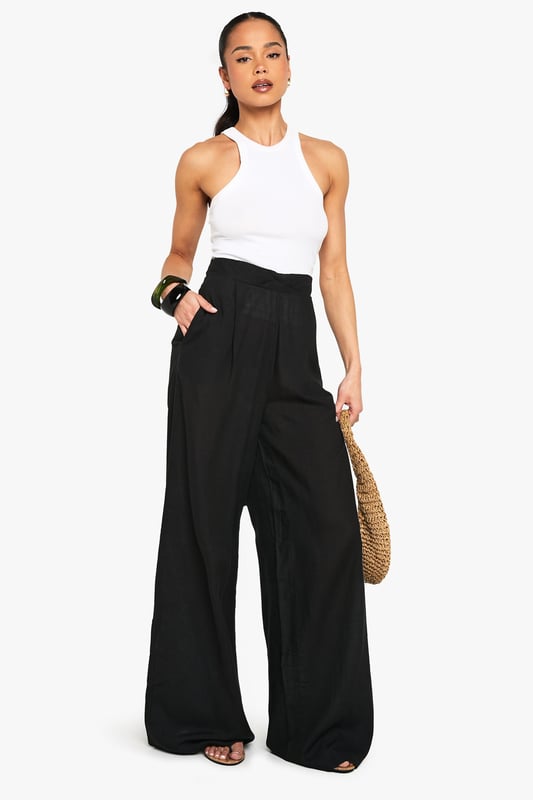 Linen Look Wide Leg Relaxed Fit Trousers Wide leg design for a relaxed, breezy silhouette
High-waisted fit accentuates the waistline
Linen-look fabric offers a lightweight, breathable feel
Side pockets add functionality to the stylish design
Versatile trousers suitable for various casual occasions
Embrace effortless chic with these wide leg relaxed fit trousers from Boohoo. The linen-look fabric lends a laid-back, summery vibe to your ensemble, perfect for those balmy days and casual outings. Style these trousers with a cropped wrap top for a coordinated look that's both trendy and comfortable. The high-waisted design flatters your figure, while the relaxed fit through the legs ensures unrestricted movement. Pair with flat sandals for a day of shopping or dress up with wedges for a casual dinner date. These trousers are a versatile addition to your wardrobe, easily transitioning from beachside strolls to family gatherings. The side pockets offer practicality without compromising on style. For a complete look, accessorise with oversized sunglasses and a woven tote bag, channelling that effortless British summer style.