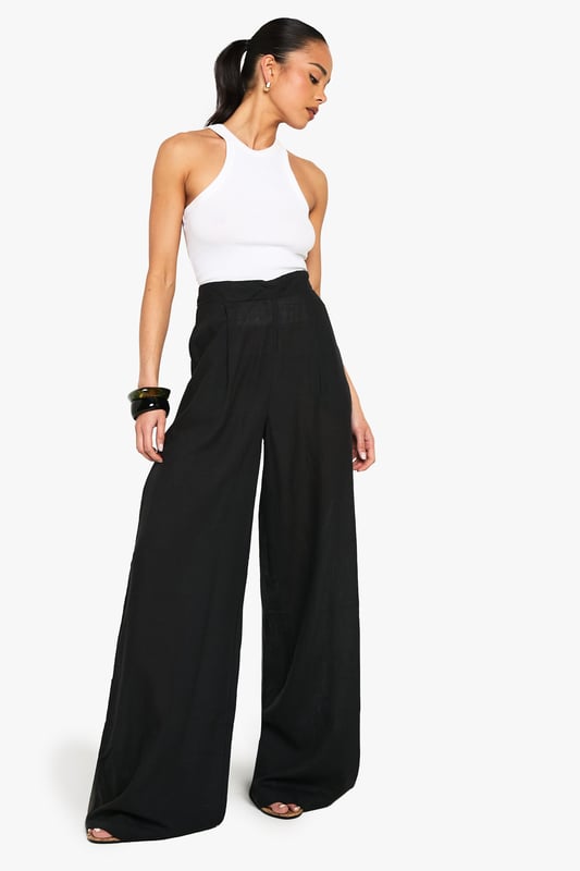 Linen Look Wide Leg Relaxed Fit Trousers Wide leg design for a relaxed, breezy silhouette
High-waisted fit accentuates the waistline
Linen-look fabric offers a lightweight, breathable feel
Side pockets add functionality to the stylish design
Versatile trousers suitable for various casual occasions
Embrace effortless chic with these wide leg relaxed fit trousers from Boohoo. The linen-look fabric lends a laid-back, summery vibe to your ensemble, perfect for those balmy days and casual outings. Style these trousers with a cropped wrap top for a coordinated look that's both trendy and comfortable. The high-waisted design flatters your figure, while the relaxed fit through the legs ensures unrestricted movement. Pair with flat sandals for a day of shopping or dress up with wedges for a casual dinner date. These trousers are a versatile addition to your wardrobe, easily transitioning from beachside strolls to family gatherings. The side pockets offer practicality without compromising on style. For a complete look, accessorise with oversized sunglasses and a woven tote bag, channelling that effortless British summer style.