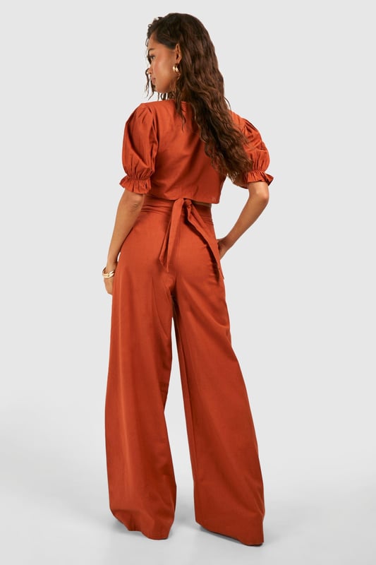 Wide leg design for a relaxed, breezy silhouette
        High-waisted fit accentuates the waistline
        Linen-look fabric offers a lightweight, breathable feel
        Side pockets add functionality to the stylish design
        Versatile trousers suitable for various casual occasions
    
    Embrace effortless chic with these wide leg relaxed fit trousers from Boohoo. The linen-look fabric lends a laid-back, summery vibe to your ensemble, perfect for those balmy days and casual outings. Style these trousers with a cropped wrap top for a coordinated look that's both trendy and comfortable. The high-waisted design flatters your figure, while the relaxed fit through the legs ensures unrestricted movement. Pair with flat sandals for a day of shopping or dress up with wedges for a casual dinner date. These trousers are a versatile addition to your wardrobe, easily transitioning from beachside strolls to family gatherings. The side pockets offer practicality without compromising on style. For a complete look, accessorise with oversized sunglasses and a woven tote bag, channelling that effortless British summer style.