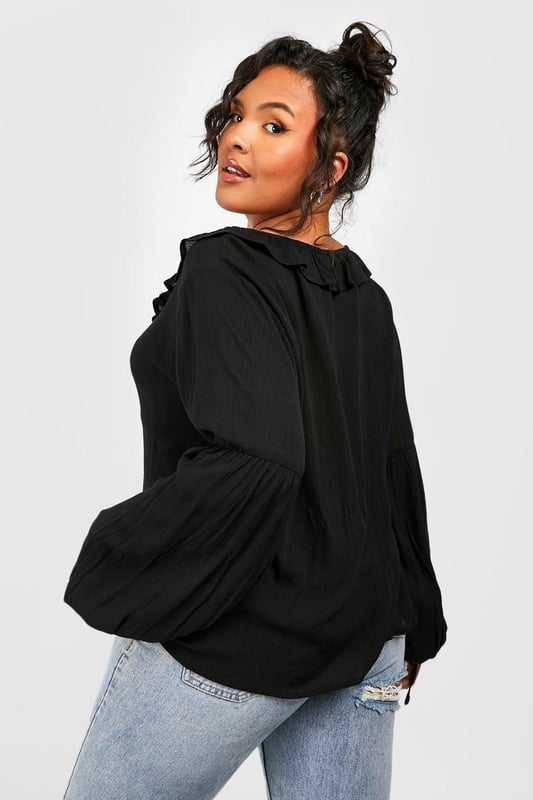 A certified wardrobe hero we can't live without, cause a storm this season in this plus size blouse from our latest collection. A smart, tailored style cut off above the waist to accentuate your curves, this floaty style can be dressed up or down, depending on the vibe. Want that 'jeans and a nice top' look? Wear a plus size white blouse with your high waisted denim and some chunky trainers and your weekend uniform is set. Detail is key with this one, that's why we're loving plus size ruffle blouses to add texture to an everyday look.Style: BlouseDesign: PlainFabric: CheeseclothLength: RegularNeckline: PlungeSleeve Length: Long Sleeve