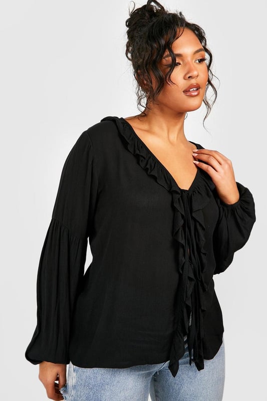 A certified wardrobe hero we can't live without, cause a storm this season in this plus size blouse from our latest collection. A smart, tailored style cut off above the waist to accentuate your curves, this floaty style can be dressed up or down, depending on the vibe. Want that 'jeans and a nice top' look? Wear a plus size white blouse with your high waisted denim and some chunky trainers and your weekend uniform is set. Detail is key with this one, that's why we're loving plus size ruffle blouses to add texture to an everyday look.Style: BlouseDesign: PlainFabric: CheeseclothLength: RegularNeckline: PlungeSleeve Length: Long Sleeve