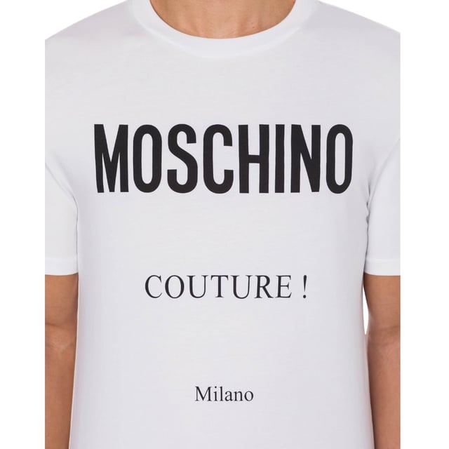 Elevate your wardrobe with the Moschino Couture White T-Shirt, a perfect blend of luxury and casual style. Crafted with premium materials, this white t-shirt offers exceptional comfort and durability, making it ideal for everyday wear. Its clean, minimalist design features subtle branding that adds a touch of sophistication without overwhelming your look. Whether paired with jeans for a relaxed outing or layered under a blazer for a chic ensemble, this versatile piece enhances your style effortlessly. Invest in timeless quality and stand out with Moschino's signature flair. 1001 WHITE T-SHIRT MALE, Made in Portugal, 100% Cotton