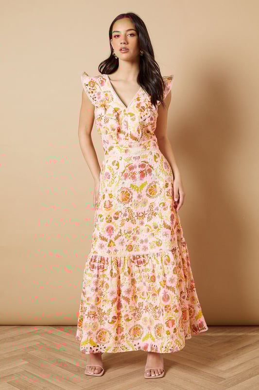 Broderie Detail V neck Midi Dress Feminine V-neckline with delicate broderie anglaise detailing
Charming flutter sleeves with ruffle trim for a playful touch
Flattering midi length with tiered hem for added movement
Defined waistband creates a beautifully structured silhouette
Striking open back design with decorative ruffle detail
This enchanting broderie detail midi dress from Oasis captures the essence of effortless daytime elegance. The intricate broderie anglaise combined with the floral pattern creates a wonderfully feminine aesthetic that's perfect for summer gatherings. Style with strappy sandals and statement earrings as seen on our model for casual brunches or garden parties. The tiered hem adds a touch of whimsy to your movement, while the defined waistband accentuates your figure beautifully. For cooler days, layer with a lightweight denim jacket and pair with white trainers for a relaxed weekend look. This versatile piece transitions seamlessly from family lunches to afternoon strolls, offering both comfort and style for your everyday wardrobe.