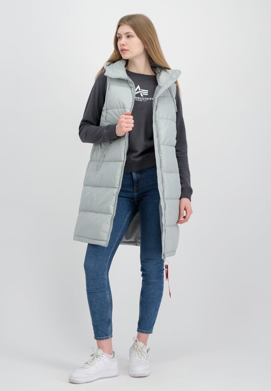Long Puffer Vest Women This is the Alpha Industries Long Puffer Vest for women. This vest features an adjustable hood and a practical inner pocket, and is padded for extra insulation. The regular fit provides exceptional comfort throughout the day.