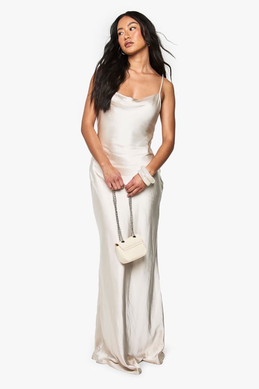 Elegant satin maxi dress with a stunning cowl neckline that drapes beautifully
        Figure-flattering silhouette with a sleek, floor-length design
        Adjustable spaghetti straps for a customised fit
        Dramatic cowl back detail adds a touch of sophistication
        Smooth, flowing fabric that glides gracefully with movement
    
    Make a striking impression at your next formal occasion with this Boohoo bridesmaid satin maxi dress. The luxurious fabric catches the light beautifully as you move, whilst the cowl neckline frames your dcolletage with effortless elegance. Style with delicate jewellery and a small clutch bag, as shown on our model, to maintain the dress's refined silhouette. Perfect for weddings, formal dinners, and black-tie events, this gown offers timeless appeal that photographs beautifully. The draped back detail adds unexpected drama when you turn, ensuring you look just as captivating from every angle. For cooler evenings, pair with a lightweight pashmina or tailored jacket to complete your sophisticated ensemble.