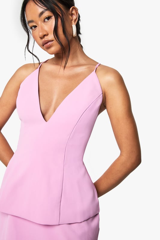 Striking plunge neckline for a bold, feminine silhouette
        Elegant peplum design creating a flattering two-piece effect
        Cross-back strappy detail adding visual interest from every angle
        Sleek crepe fabric offering a structured yet comfortable fit
        Mini length perfect for showcasing your legs and favourite heels
    
    Make a statement at your next special occasion with this sophisticated mini dress from Boohoo. The contemporary peplum silhouette creates a figure-enhancing shape whilst the deep V-neckline adds a touch of allure. The cross-back strappy detail ensures you'll turn heads coming and going. Style with strappy heeled sandals and a compact clutch bag as shown for formal events such as cocktail parties or race day outings. For cooler evenings, layer with a tailored blazer or delicate wrap. Complete your look with statement earrings and a sleek updo to showcase the beautiful neckline and back detail. This versatile piece transitions effortlessly from graduation ceremonies to wedding receptions with just a change of accessories.