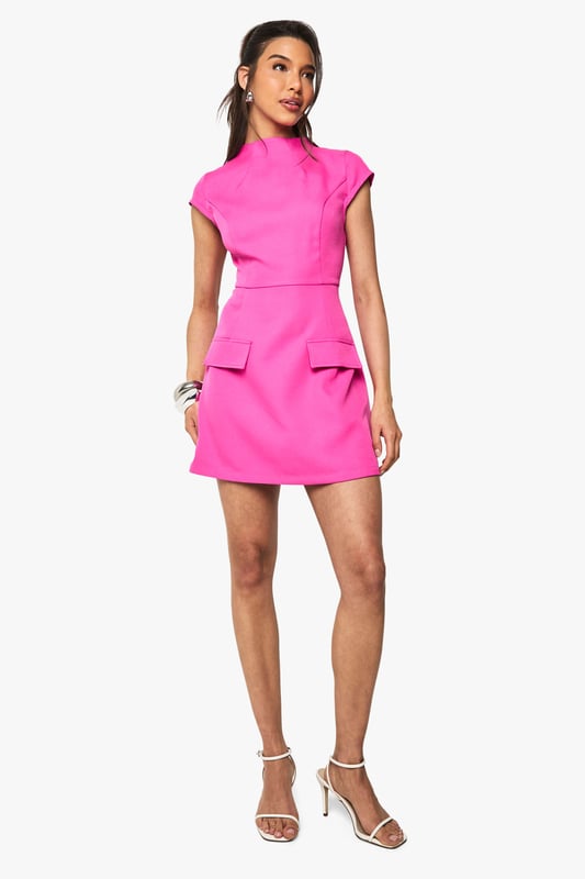 Structured woven fabric with textured finish for added dimension
        High neckline with cap sleeves for a sophisticated silhouette
        Figure-defining fitted waist that accentuates your shape
        Decorative pocket details at the hips for a modern twist
        Mini length perfect for showcasing your legs
    
    Make a statement in this head-turning mini dress from Boohoo. The high neckline and structured silhouette create a contemporary look that commands attention, whilst the textured fabric adds visual interest to this standout piece. Style with strappy heels and stacked bangles as seen on our model for a night out with the girls, or dress it down with white trainers and a denim jacket for daytime drinks. The versatile design works brilliantly for everything from cocktails at a trendy bar to birthday celebrations. The pocket details add a functional yet fashionable element to this already striking dress. Complete your look with a sleek ponytail and statement earrings to truly showcase this bold, party-ready number.