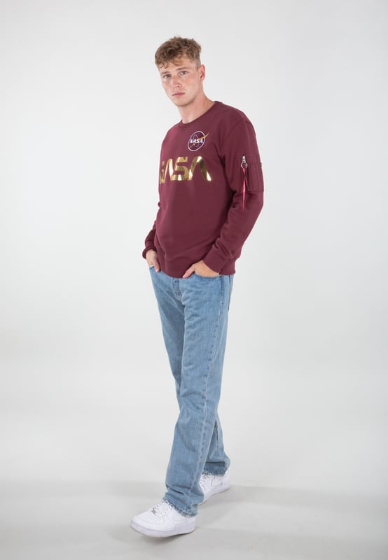 The jumper is made from a soft knitted fabric with cuffs that keep it in place. It also features a reflective Alpha Industries logo on the chest.