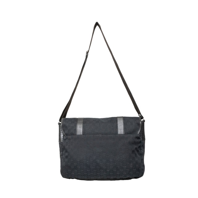 VINTAGE, RRP AS NEW
This black monogram GG canvas bag features a double buckle flap, adjustable crossbody strap, leather straps with dark silver buckles, and a black fabric interior with pockets. 
Remarks: There are minimal signs of wear and a curling on the leather.  Measurments:  width: 1168 mm height: 838 mm