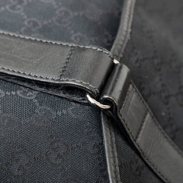 VINTAGE, RRP AS NEW
This black monogram GG canvas bag features a double buckle flap, adjustable crossbody strap, leather straps with dark silver buckles, and a black fabric interior with pockets. 
Remarks: There are minimal signs of wear and a curling on the leather.  Measurments:  width: 1168 mm height: 838 mm