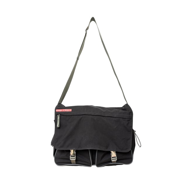 VINTAGE, RRP AS NEW
This sporty messenger bag from Prada features silver-tone hardware, an adjustable shoulder strap, three exterior pockets, nylon lining, and dual buckle closure at the front. Measurments:  width: 965 mm height: 812 mm