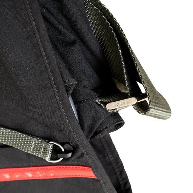 VINTAGE, RRP AS NEW
This sporty messenger bag from Prada features silver-tone hardware, an adjustable shoulder strap, three exterior pockets, nylon lining, and dual buckle closure at the front. Measurments:  width: 965 mm height: 812 mm