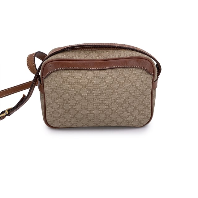VINTAGE, RRP AS NEW
Embrace classic elegance with this beautiful vintage Celine small Macadam crossbody bag-a timeless piece that captures the charm of 1990s-era luxury. Expertly crafted from Celine's signature beige Macadam vinyl canvas and accented with light brown genuine leather trim, this compact silhouette is both chic and practical.  The bag features gold metal hardware that adds a touch of shine, while the adjustable leather shoulder strap ensures comfortable crossbody wear. An upper zipper closure opens to reveal a clean leather-lined interior, complete with a side zip pocket for your essentials.  Inside, the "Celine Paris" tag and Made in Italy stamp attest to its craftsmanship. Whether you're strolling through the city or dressing up your everyday look, this vintage Celine crossbody brings understated sophistication to every outfit Condition Rating: B - VERY GOOD CONDITIONCondition Details: Gently used. Some wear of use (scratches) leather trim and shoulder strap (especially on bottom corners). Some scratches on the internal lining. Please check the photos carefully and ask if you need to know more details or if you have any doubts.Measurements (cm):Depth: 7.6Height: 12.7Length: 19.1Other Details: Dustbag? NoKeys? NoBox? No Measurments:  width: 76 mm length: 191 mm height: 127 mm