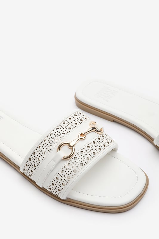 Wheres That From Womens 'Natalie' Sliders With Geometric Strap And Metal Detail Step into timeless elegance with these Natalie Sliders With Geometric Strap And Metal Detail. Designed with a chic metallic horse-bit buckle, they effortlessly blend sophistication and comfort. The perforated upper adds breathable style, while the slip-on design makes them ideal for effortless wear from day to night. Perfect for holidays, casual brunches, or a polished everyday look. Key Features: • Material: Faux leather upper with a cushioned insole for all-day comfort • Design: Perforated detailing with a stylish horse-bit buckle accent • Closure: Easy slip-on style for convenience
