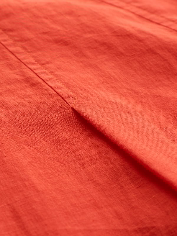 A relaxed midi dress with a round neckline, this piece has a flattering flared silhouette accented by soft pleat details. Finished with a unique coconut button shoulder opening, it’s a light, flowing option for everyday wear.