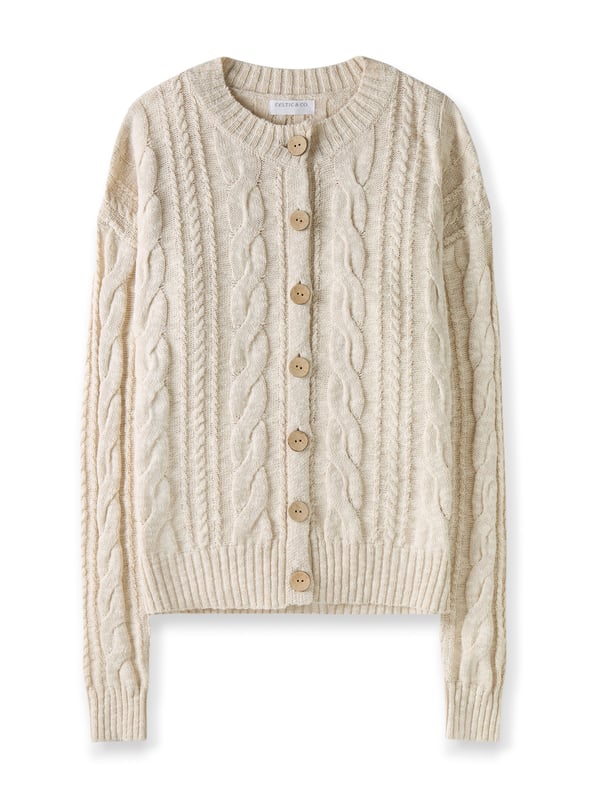 This cardigan has a classic cable-knit pattern with a relaxed, drop-shoulder shape, finished with natural coconut buttons. The cotton-linen blend lends an airy feel, while the crew neckline and boxy fit create an easy, everyday layer.