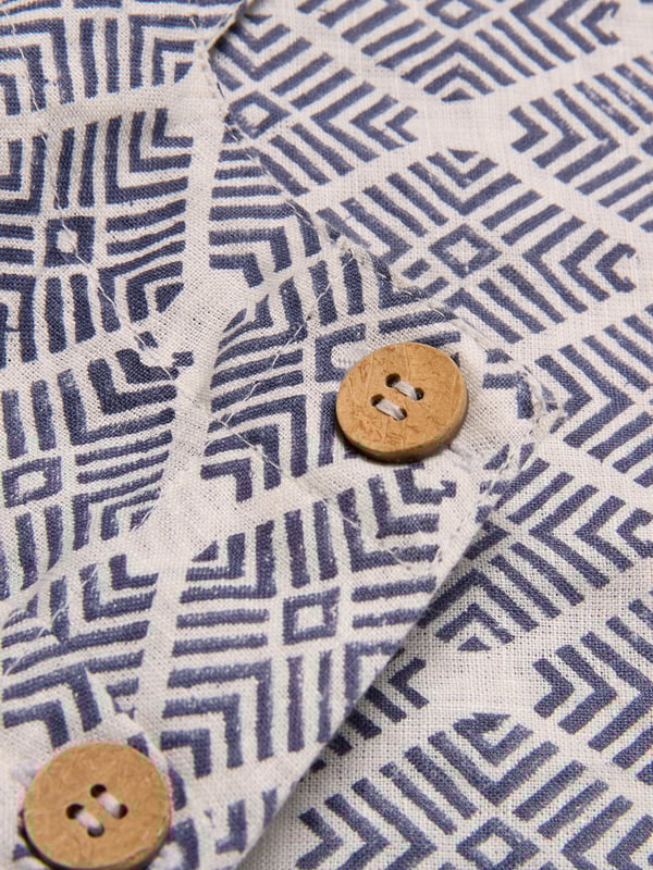 Featuring a square neckline and buttoned side placket detail, this top offers a straight and easy fit. Its simple yet refined design makes it an essential piece for layering or wearing alone. The printed version of this style is achieved by the artisanal technique of wood-block printing. Using a hand carved wood block, the design is repeatedly stamped on the fabric by artisans to achieve a unique, individual garment.