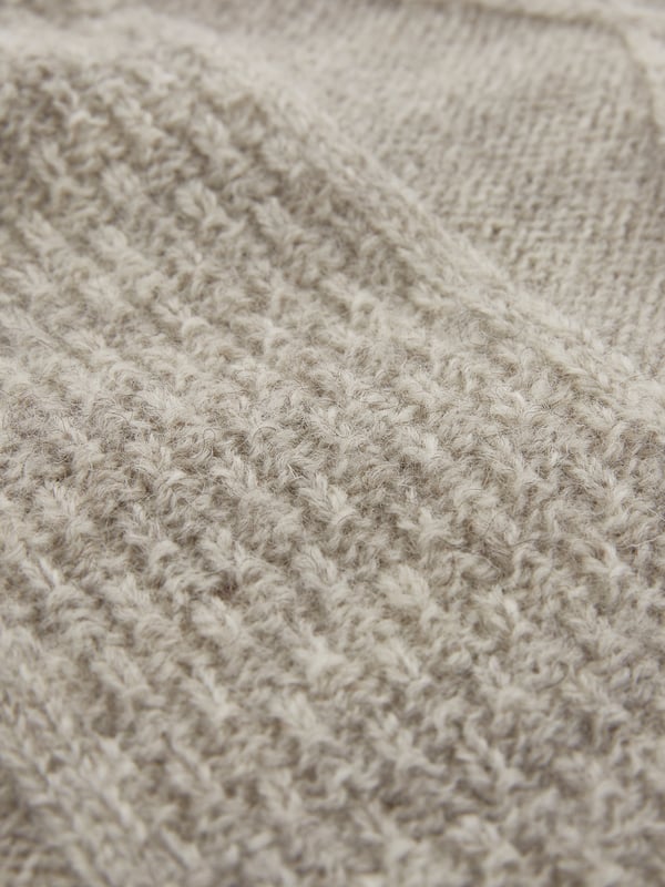 We're proud to say that from farm to factory our beautiful Gansey jumper is produced entirely in Britain. A take on the traditional fisherman’s Gansey jumper, we’ve been inspired by stitch patterns used historically in Cornish fishing villages. Details include a boxy, drop shoulder body shape with T sleeves and a ribbed and cast off rolled collar. Panelled stitch patterns run across the top half of the jumper, plus it is ‘knitted in the round’, meaning it is seamless, just as the traditional fisherman’s jumpers were made. Made using undyed wool, the natural fibres keep you warm in cold weather, but are breathable too.