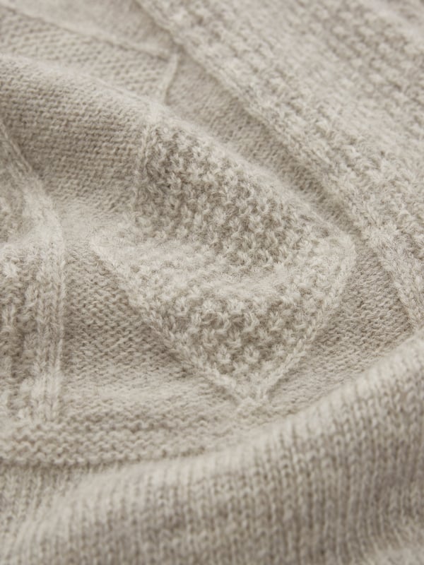 We're proud to say that from farm to factory our beautiful Gansey jumper is produced entirely in Britain. A take on the traditional fisherman’s Gansey jumper, we’ve been inspired by stitch patterns used historically in Cornish fishing villages. Details include a boxy, drop shoulder body shape with T sleeves and a ribbed and cast off rolled collar. Panelled stitch patterns run across the top half of the jumper, plus it is ‘knitted in the round’, meaning it is seamless, just as the traditional fisherman’s jumpers were made. Made using undyed wool, the natural fibres keep you warm in cold weather, but are breathable too.