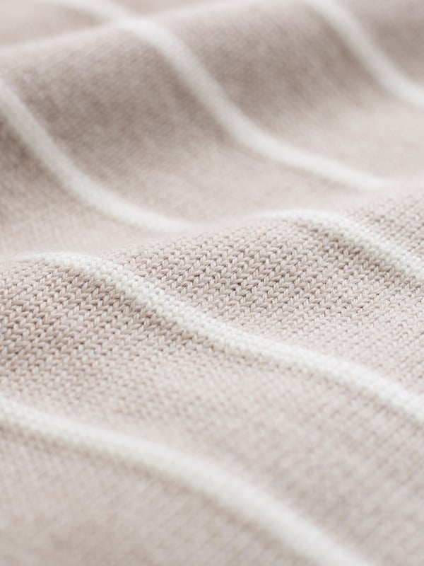 Our Merino V Neck Jumper has been seamlessly knitted in Britain with full-length sleeves and a ribbed hem and cuffs. The clean, luxury handle of the merino wool offers warmth to a traditional v-neck style in a contemporary breton stripe design. Whether you're layering up for the evening or keeping it casual, this jumper is a versatile choice for any occasion.