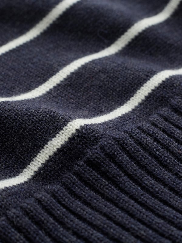 Our Merino V Neck Jumper has been seamlessly knitted in Britain with full-length sleeves and a ribbed hem and cuffs. The clean, luxury handle of the merino wool offers warmth to a traditional v-neck style in a contemporary breton stripe design. Whether you're layering up for the evening or keeping it casual, this jumper is a versatile choice for any occasion.