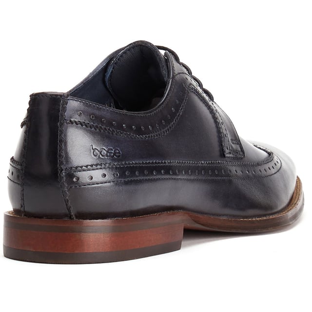 Base London Havisham Leather Men's Navy Derby Shoes Crafted from smooth leather uppers, the Havisham formal men's shoe features beautiful brogue detailing and a wing tip that runs all the way to the heel where a Base brand can be found embossed into the leather.